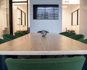 Meeting Room with the Table Focused and the presentation TV in view